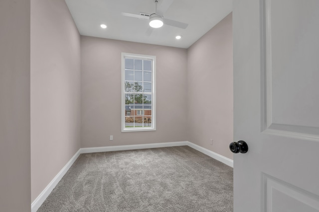 carpeted spare room featuring ceiling fan