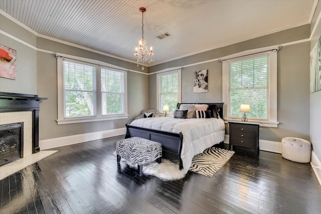 413 S Liberty St, Waynesboro, GA 30830 - bedroom featuring a chandelier, baseboards, a fireplace, wood-type flooring, and crown molding