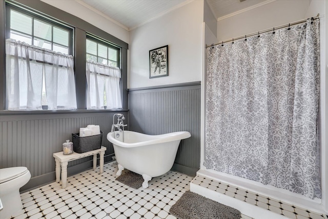413 S Liberty St, Waynesboro, GA 30830 - full bathroom featuring a wainscoted wall, tile patterned floors, crown molding, toilet, and a freestanding tub