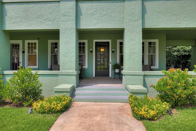 413 S Liberty St, Waynesboro, GA 30830 - doorway to property with stucco siding and a porch