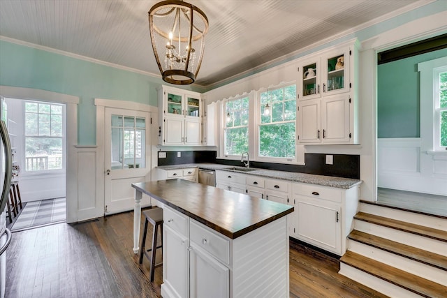 413 S Liberty St, Waynesboro, GA 30830 - kitchen with a sink, stainless steel dishwasher, plenty of natural light, white cabinets, and wainscoting