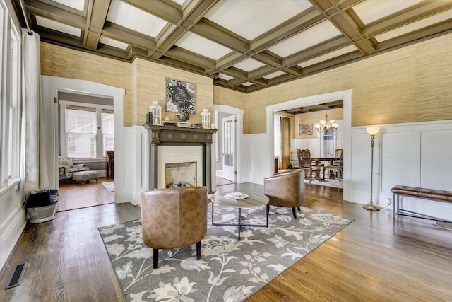 413 S Liberty St, Waynesboro, GA 30830 - living room featuring coffered ceiling, a fireplace, beam ceiling, a chandelier, and wood finished floors