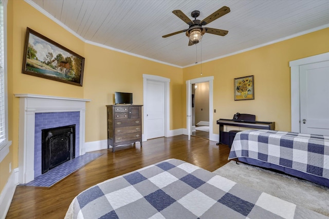 413 S Liberty St, Waynesboro, GA 30830 - bedroom featuring wood finished floors, a fireplace, ornamental molding, baseboards, and a ceiling fan