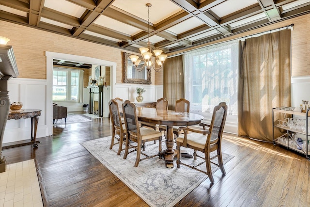 413 S Liberty St, Waynesboro, GA 30830 - dining room featuring coffered ceiling, beamed ceiling, a decorative wall, a chandelier, and hardwood / wood-style floors