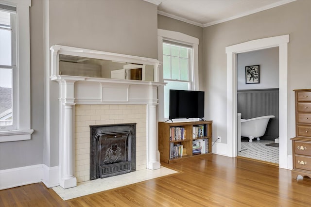 413 S Liberty St, Waynesboro, GA 30830 - unfurnished living room featuring wood finished floors, a fireplace, crown molding, and baseboards