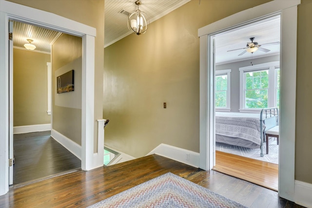 413 S Liberty St, Waynesboro, GA 30830 - hallway featuring crown molding, wood-type flooring, an upstairs landing, and baseboards