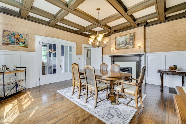 413 S Liberty St, Waynesboro, GA 30830 - dining room featuring a decorative wall, coffered ceiling, beamed ceiling, a chandelier, and hardwood / wood-style floors
