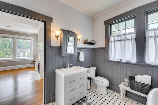 413 S Liberty St, Waynesboro, GA 30830 - bathroom featuring crown molding, a wainscoted wall, toilet, vanity, and wood finished floors