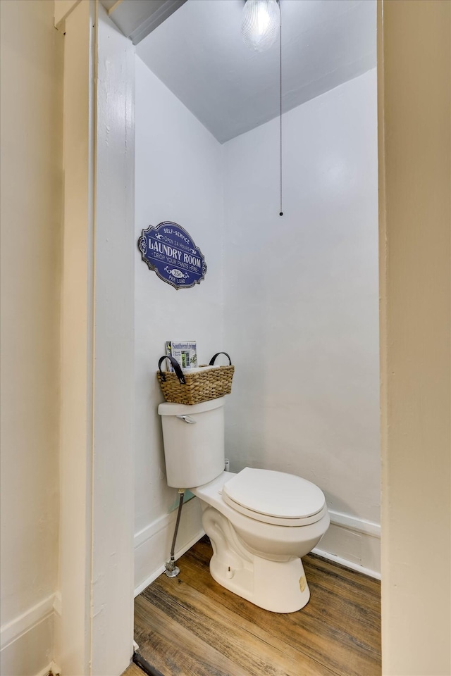 413 S Liberty St, Waynesboro, GA 30830 - bathroom with toilet, wood finished floors, and baseboards
