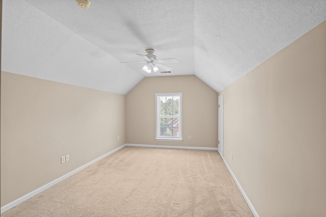 703 Talon Ct, Evans, GA 30809 - bonus room featuring baseboards, a ceiling fan, light carpet, lofted ceiling, and a textured ceiling