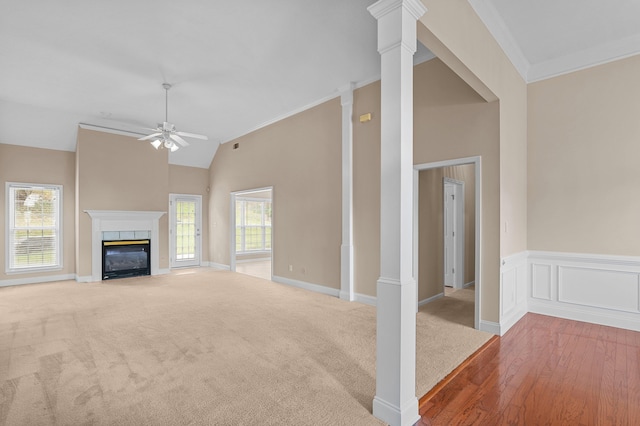 703 Talon Ct, Evans, GA 30809 - unfurnished living room with ceiling fan, ornamental molding, a fireplace with flush hearth, wood finished floors, and high vaulted ceiling