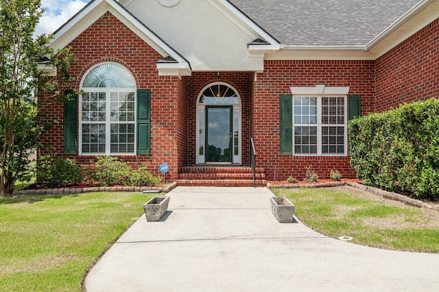 703 Talon Ct, Evans, GA 30809 - doorway to property featuring brick siding, a yard, and roof with shingles