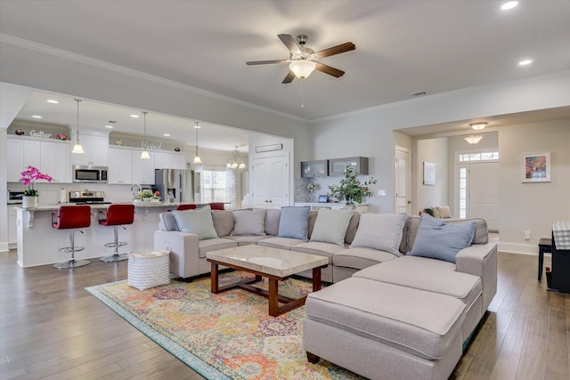 living room featuring crown molding, hardwood / wood-style floors, and ceiling fan