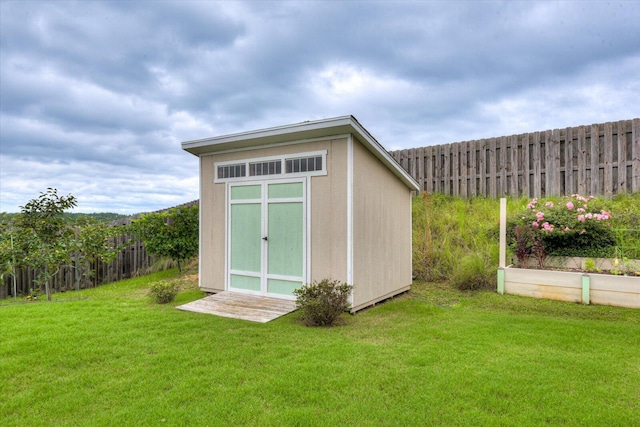 view of outbuilding with a lawn