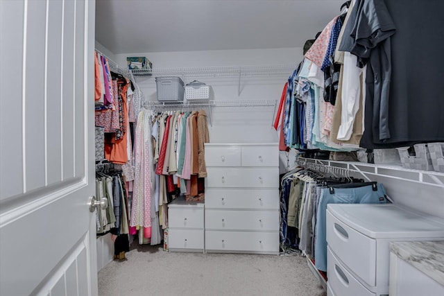 walk in closet with washing machine and dryer