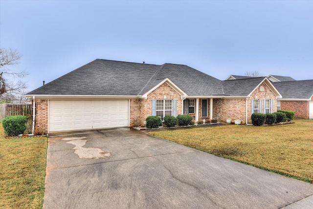 ranch-style house with a front lawn, driveway, and brick siding