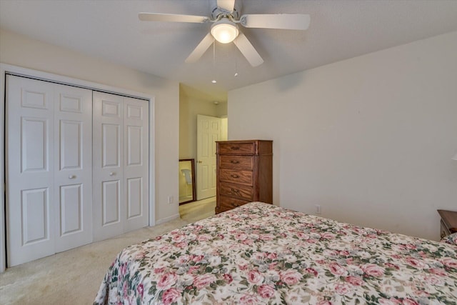 carpeted bedroom featuring a closet and ceiling fan