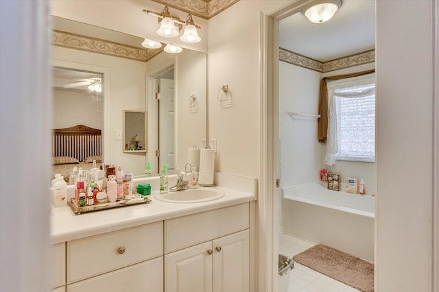 bathroom with a garden tub, vanity, and ceiling fan