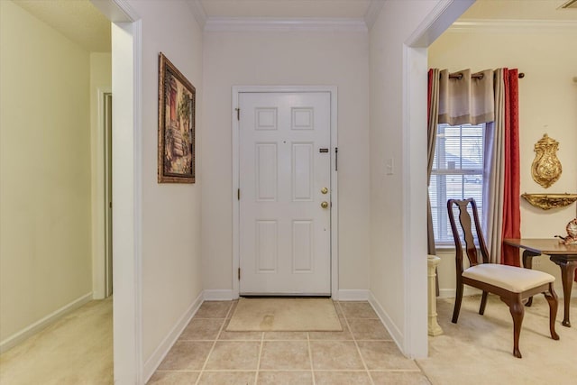 foyer with light tile patterned floors, baseboards, and ornamental molding