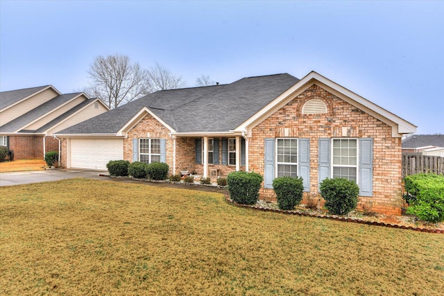 ranch-style home with concrete driveway, fence, a garage, brick siding, and a front yard
