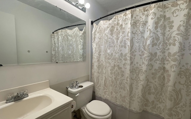 bathroom featuring vanity, a shower with curtain, a textured ceiling, and toilet