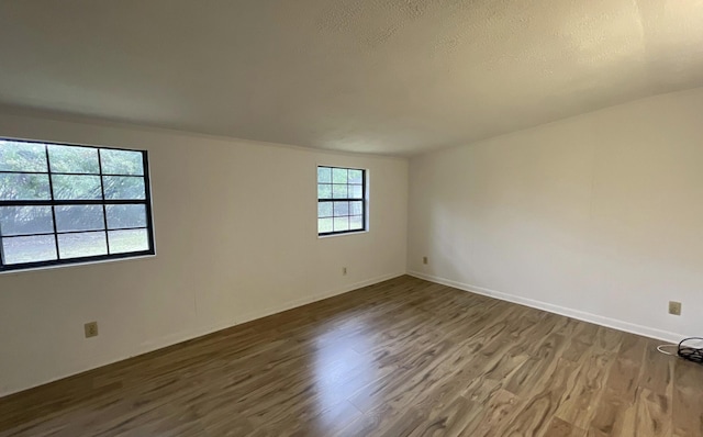 unfurnished room with dark hardwood / wood-style flooring