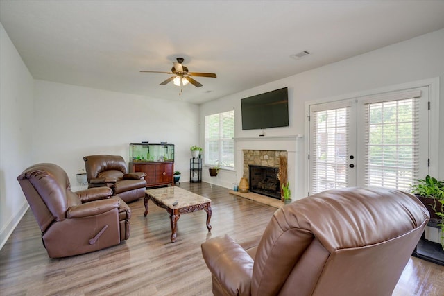 203 Preston Ct, North Augusta, SC 29860 - living room with a stone fireplace, a ceiling fan, baseboards, light wood-type flooring, and visible vents