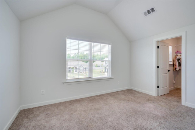 203 Preston Ct, North Augusta, SC 29860 - unfurnished bedroom with a walk in closet, carpet, lofted ceiling, and visible vents