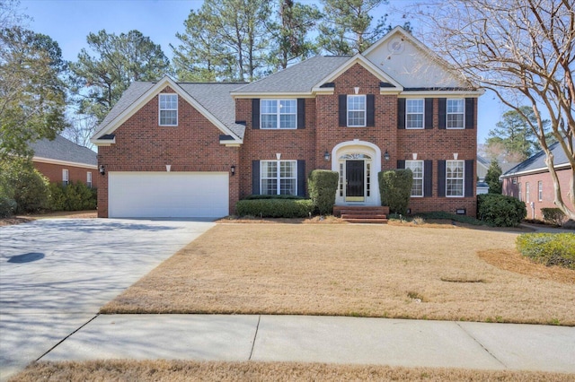 colonial-style house featuring a garage, crawl space, brick siding, and driveway