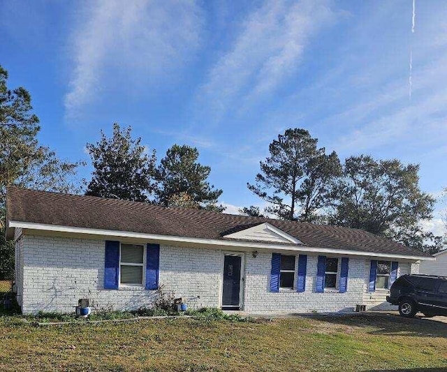 ranch-style house with a front lawn