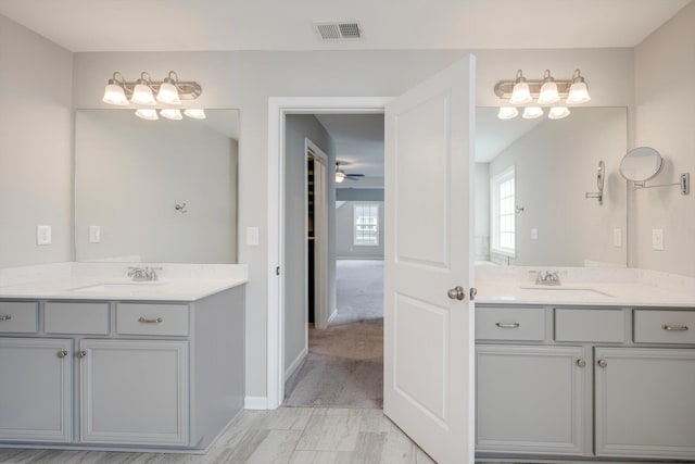 215 Palisades Rdg, Evans, GA 30809 - bathroom featuring two vanities, a ceiling fan, and baseboards