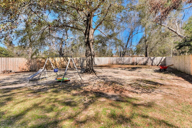 view of yard featuring a playground and a fenced backyard