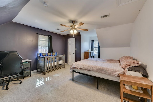 bedroom featuring lofted ceiling, carpet, visible vents, and baseboards