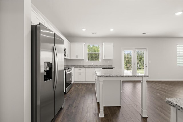 1256 Birch Cir, Grovetown, GA 30813 - kitchen featuring stainless steel appliances, dark wood finished floors, white cabinetry, a center island, and a sink