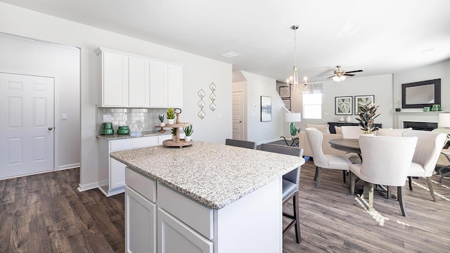 1256 Birch Cir, Grovetown, GA 30813 - kitchen featuring open floor plan, a center island, dark wood finished floors, a breakfast bar area, and white cabinets