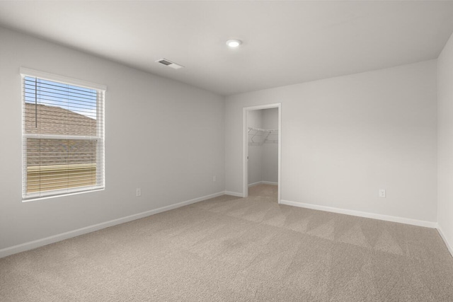 1256 Birch Cir, Grovetown, GA 30813 - unfurnished bedroom featuring light carpet, baseboards, a walk in closet, and a closet