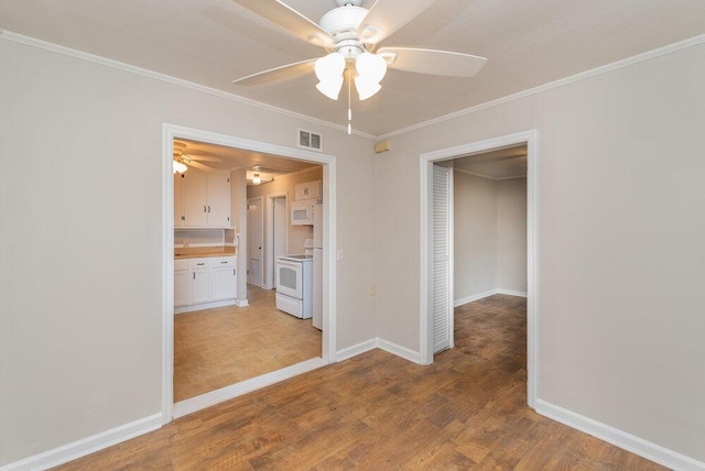 unfurnished room with wood-type flooring, ceiling fan, and ornamental molding