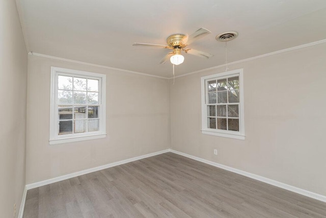 empty room featuring hardwood / wood-style floors, ceiling fan, and ornamental molding