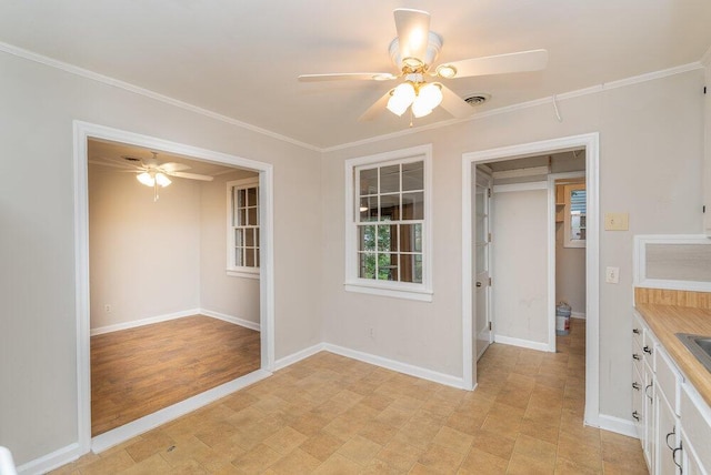 interior space with a closet, ceiling fan, and crown molding