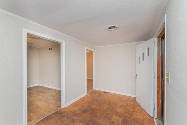 corridor featuring parquet flooring, a textured ceiling, and ornamental molding