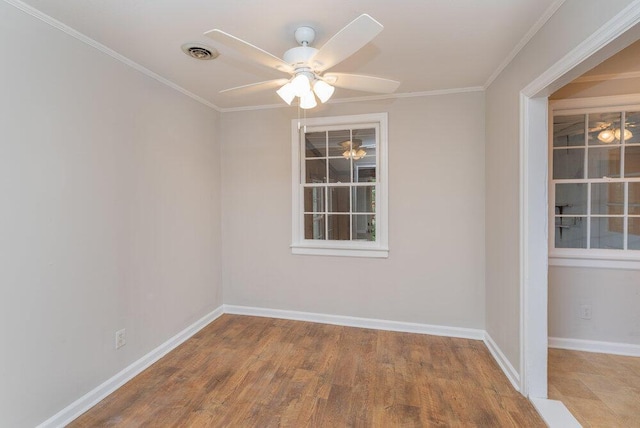 empty room with hardwood / wood-style flooring, ceiling fan, and crown molding