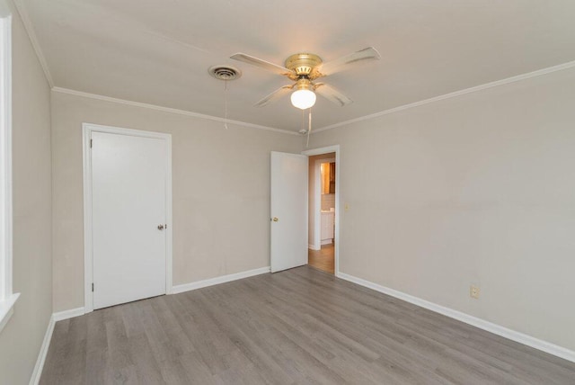 spare room with ceiling fan, crown molding, and light hardwood / wood-style flooring