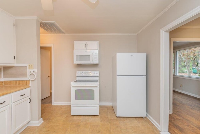 kitchen featuring white appliances, white cabinetry, and crown molding