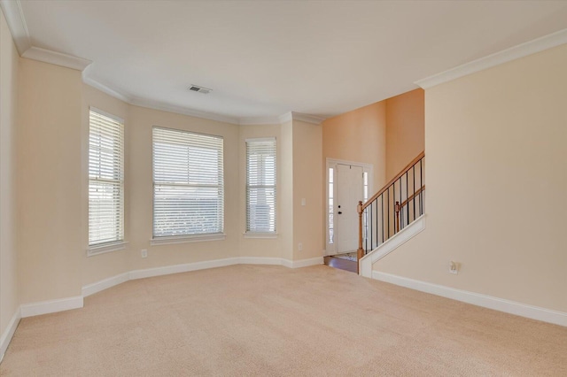 carpeted empty room with crown molding