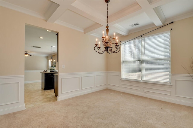 spare room with beamed ceiling, light carpet, and coffered ceiling