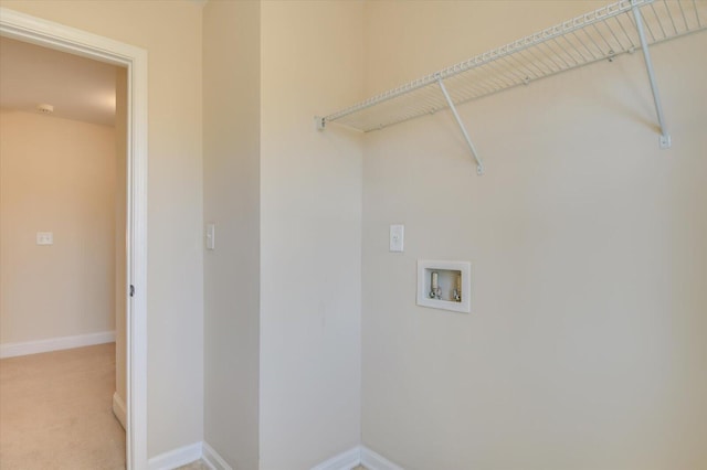 laundry room with washer hookup and light carpet