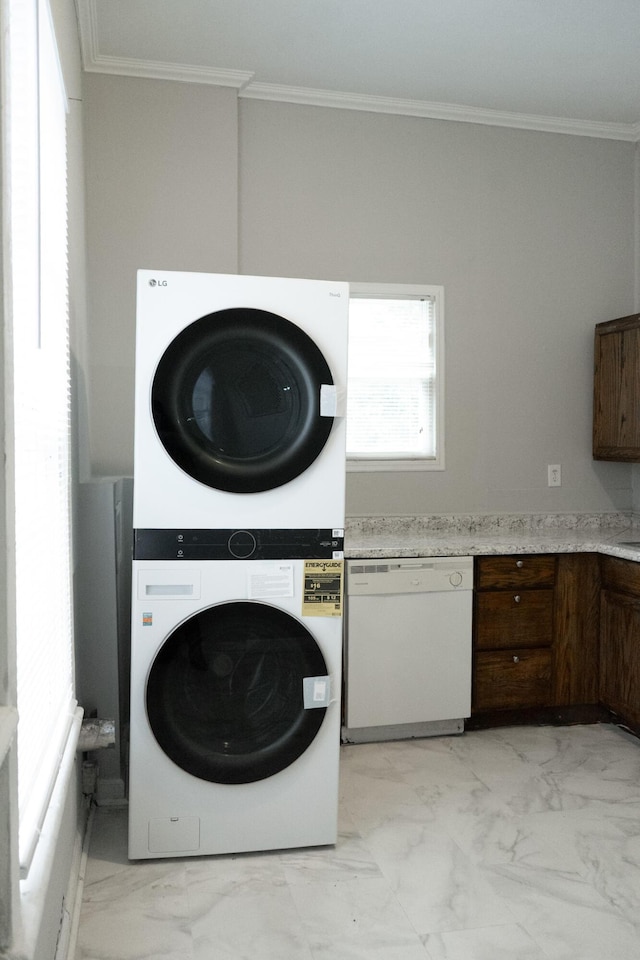 413 2nd St, Augusta, GA 30901 - laundry room with stacked washing machine and dryer, light marble finish floors, and ornamental molding