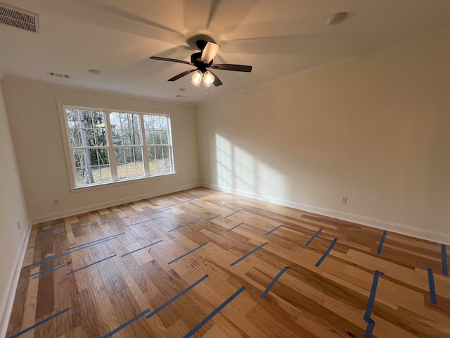 spare room featuring hardwood / wood-style floors, ceiling fan, and ornamental molding