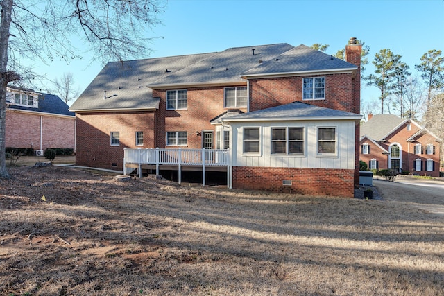 rear view of house with a wooden deck