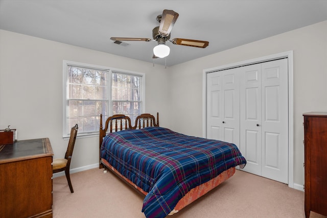 carpeted bedroom featuring a closet and ceiling fan